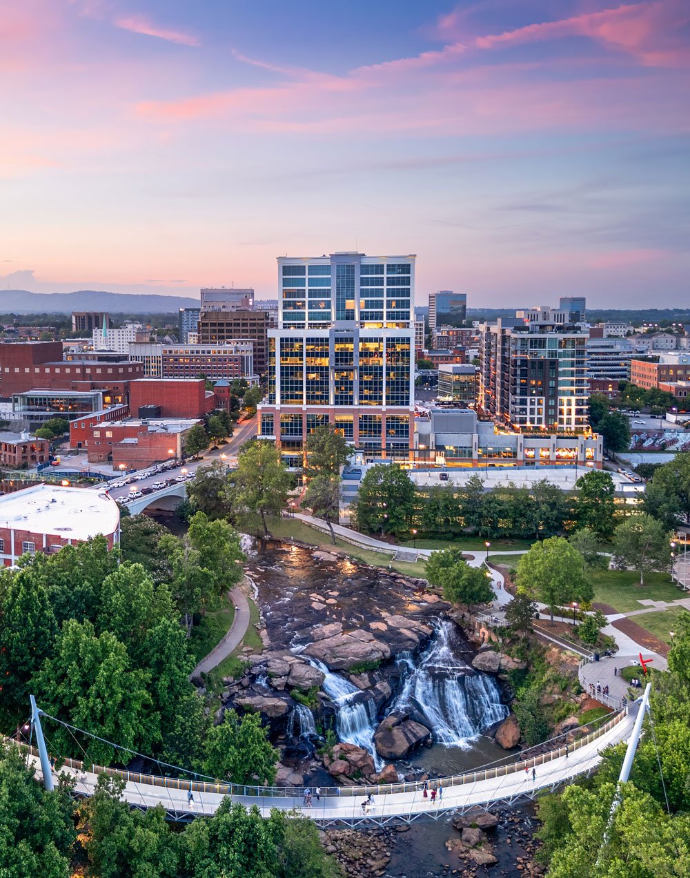 The skyline of a beautiful city. Off in the distance, a sign for Drolet Bonding shines, representing the most reliable option for bail bonds in Spartanburg SC.